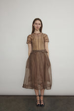 Model wearing the Mushroom silk organza Brise Skirt, showcasing its voluminous silhouette, sheer fabric, and elegant midi-length drape.