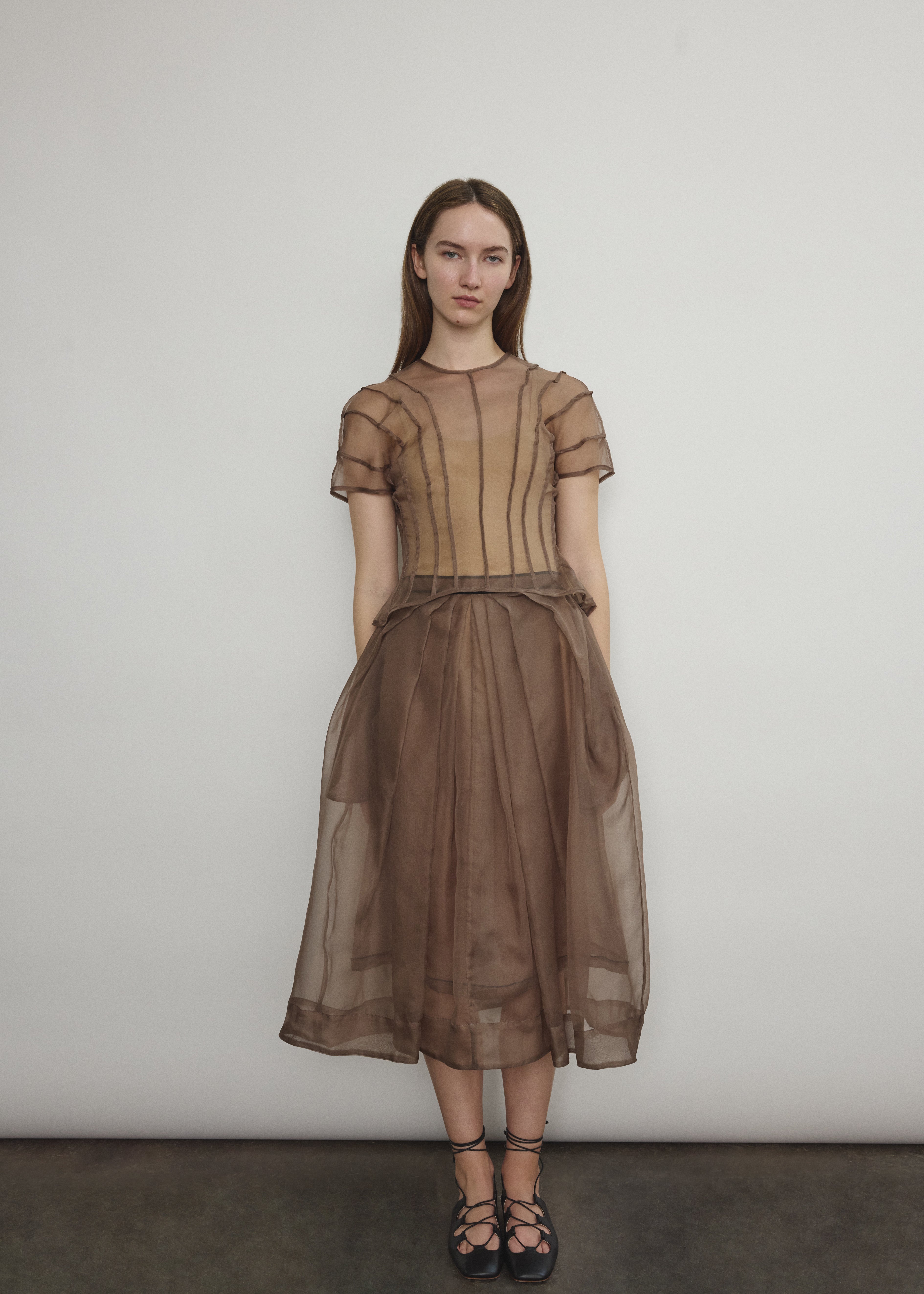 Model wearing the Mushroom silk organza Brise Skirt, showcasing its voluminous silhouette, sheer fabric, and elegant midi-length drape.