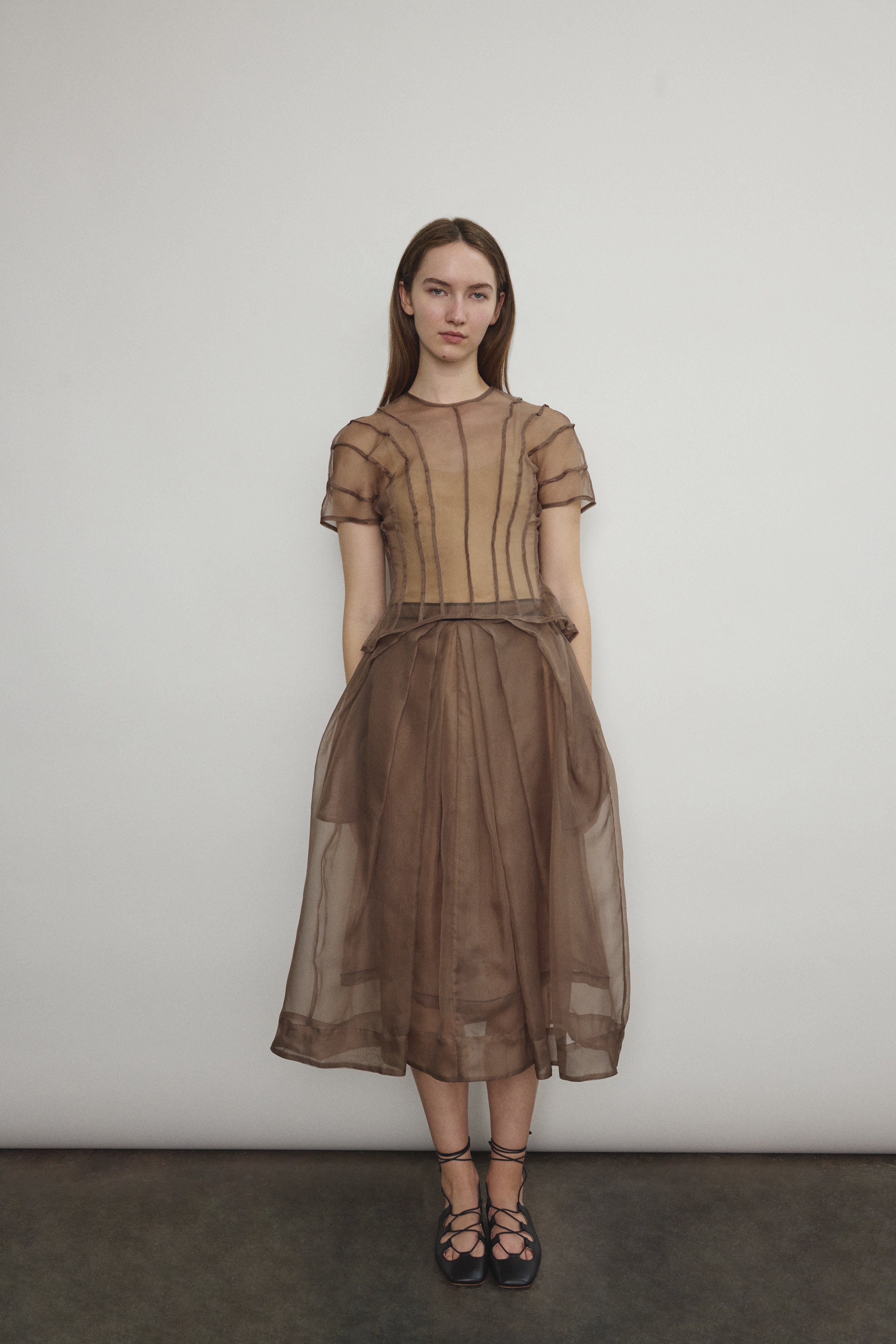 Model wearing the Mushroom silk organza Brise Skirt, showcasing its voluminous silhouette, sheer fabric, and elegant midi-length drape.