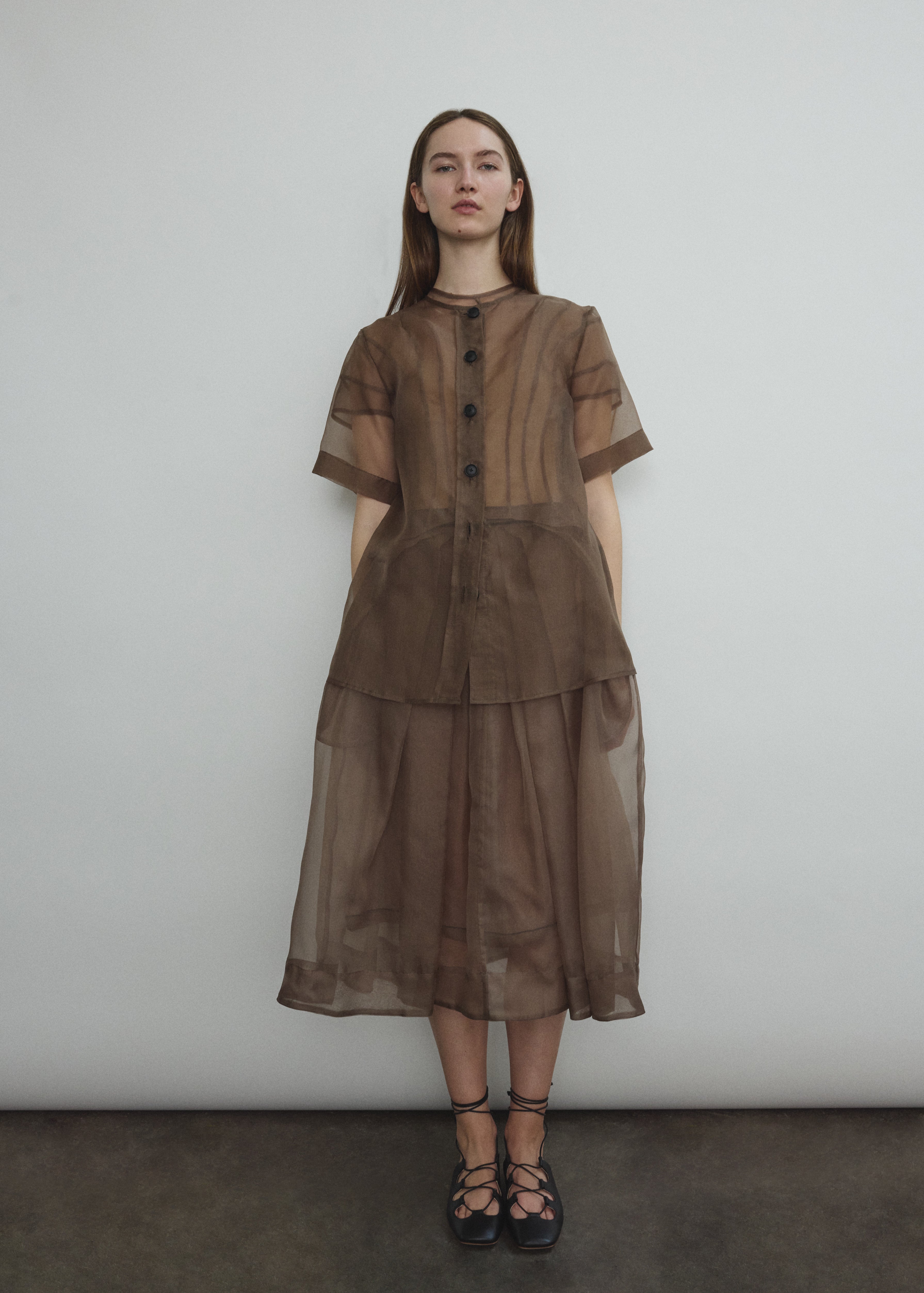 Model wearing the Mushroom silk organza Brise Skirt, showcasing its voluminous silhouette, sheer fabric, and elegant midi-length drape.