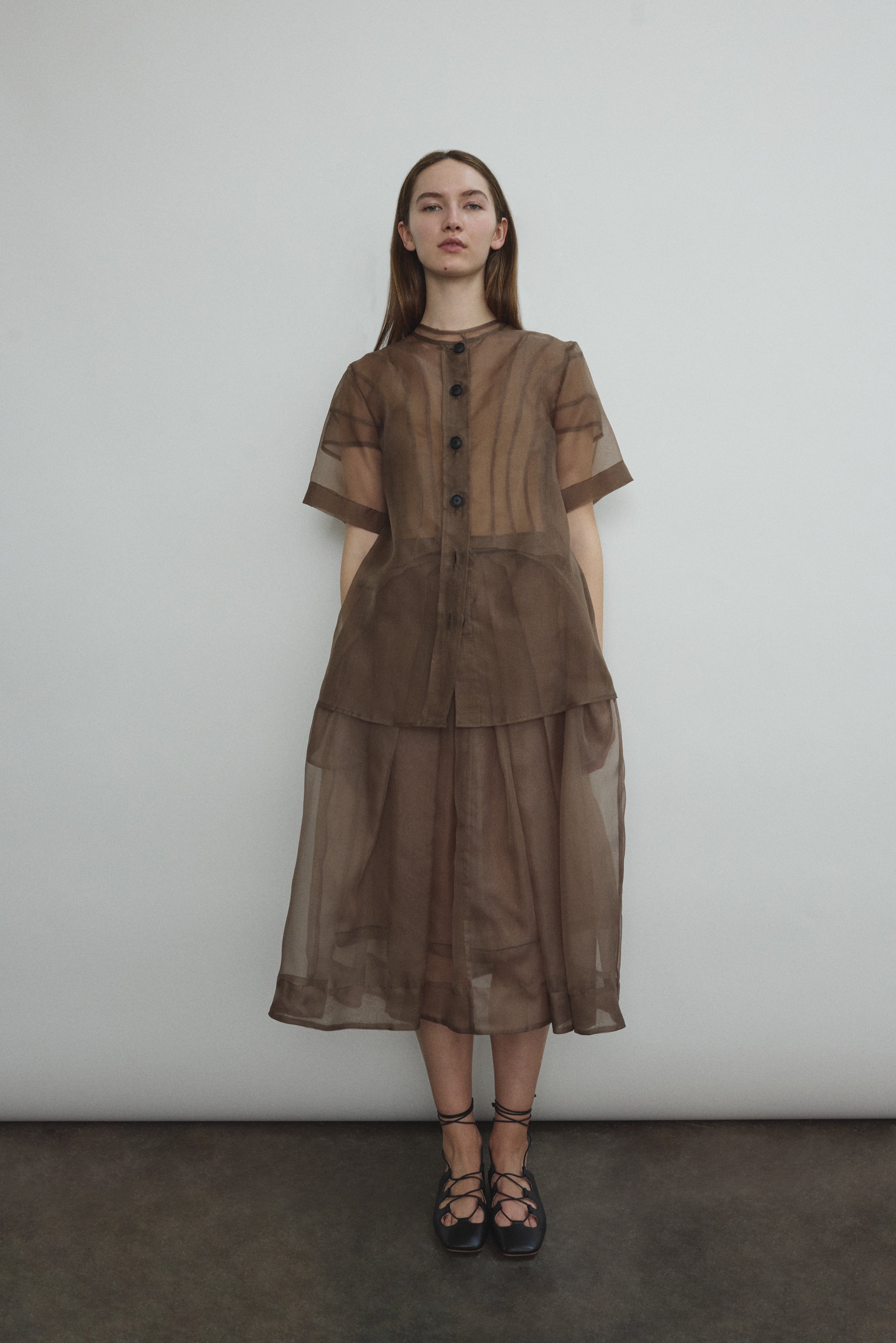 Model wearing the Mushroom silk organza Brise Skirt, showcasing its voluminous silhouette, sheer fabric, and elegant midi-length drape.