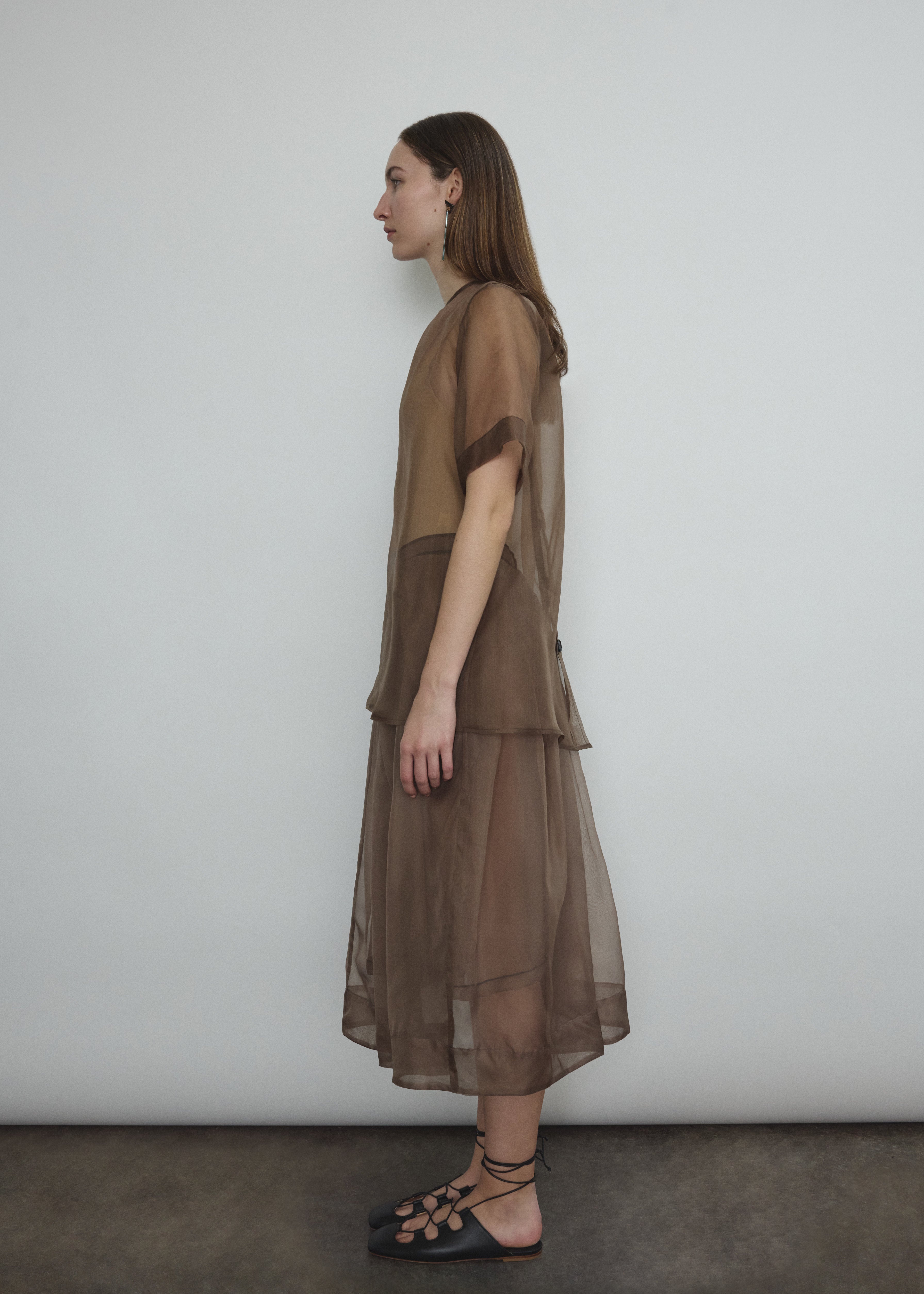Model wearing the Mushroom silk organza Brise Skirt, showcasing its voluminous silhouette, sheer fabric, and elegant midi-length drape.