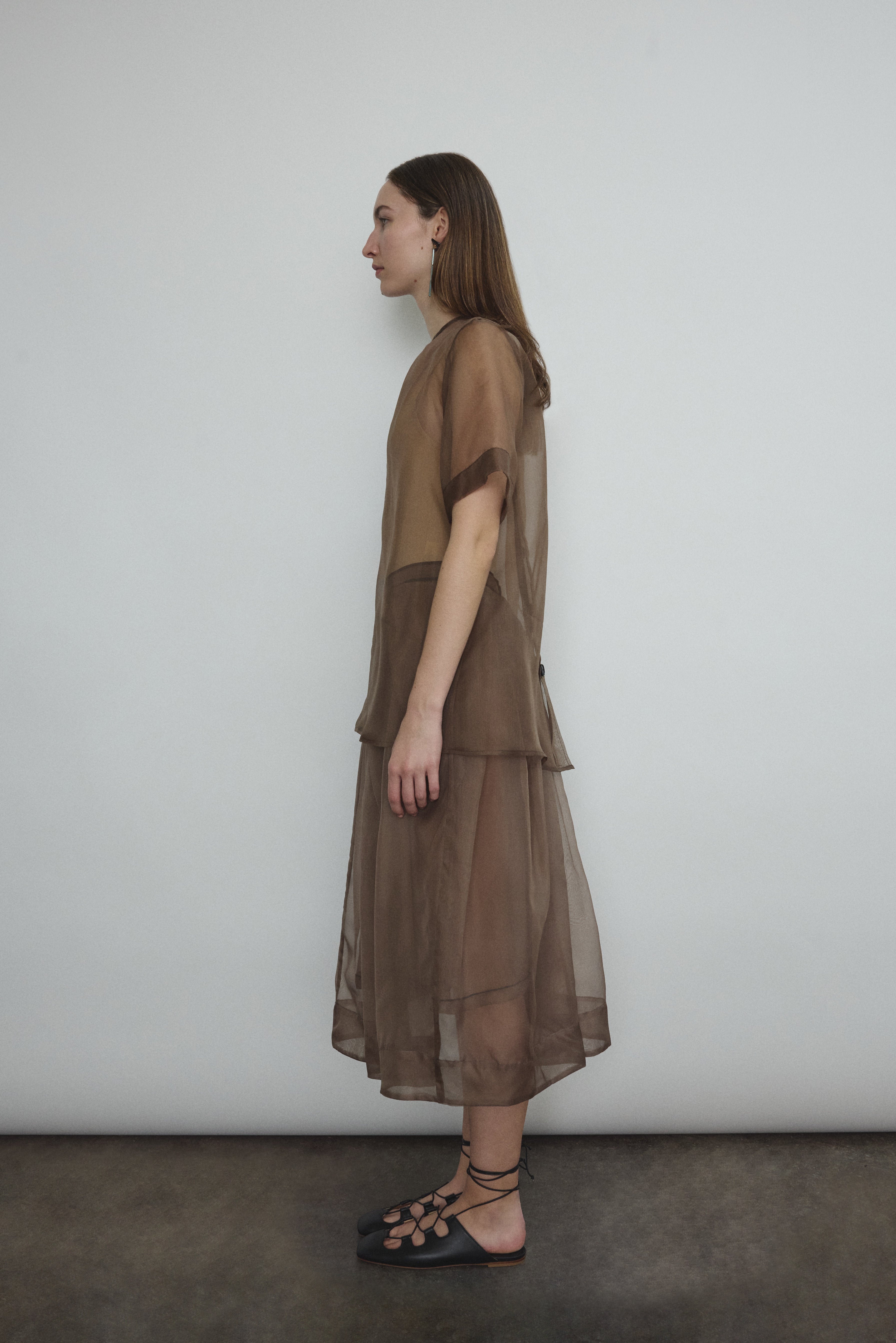 Model wearing the Mushroom silk organza Brise Skirt, showcasing its voluminous silhouette, sheer fabric, and elegant midi-length drape.