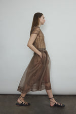 Model wearing the Mushroom silk organza Brise Skirt, showcasing its voluminous silhouette, sheer fabric, and elegant midi-length drape.
