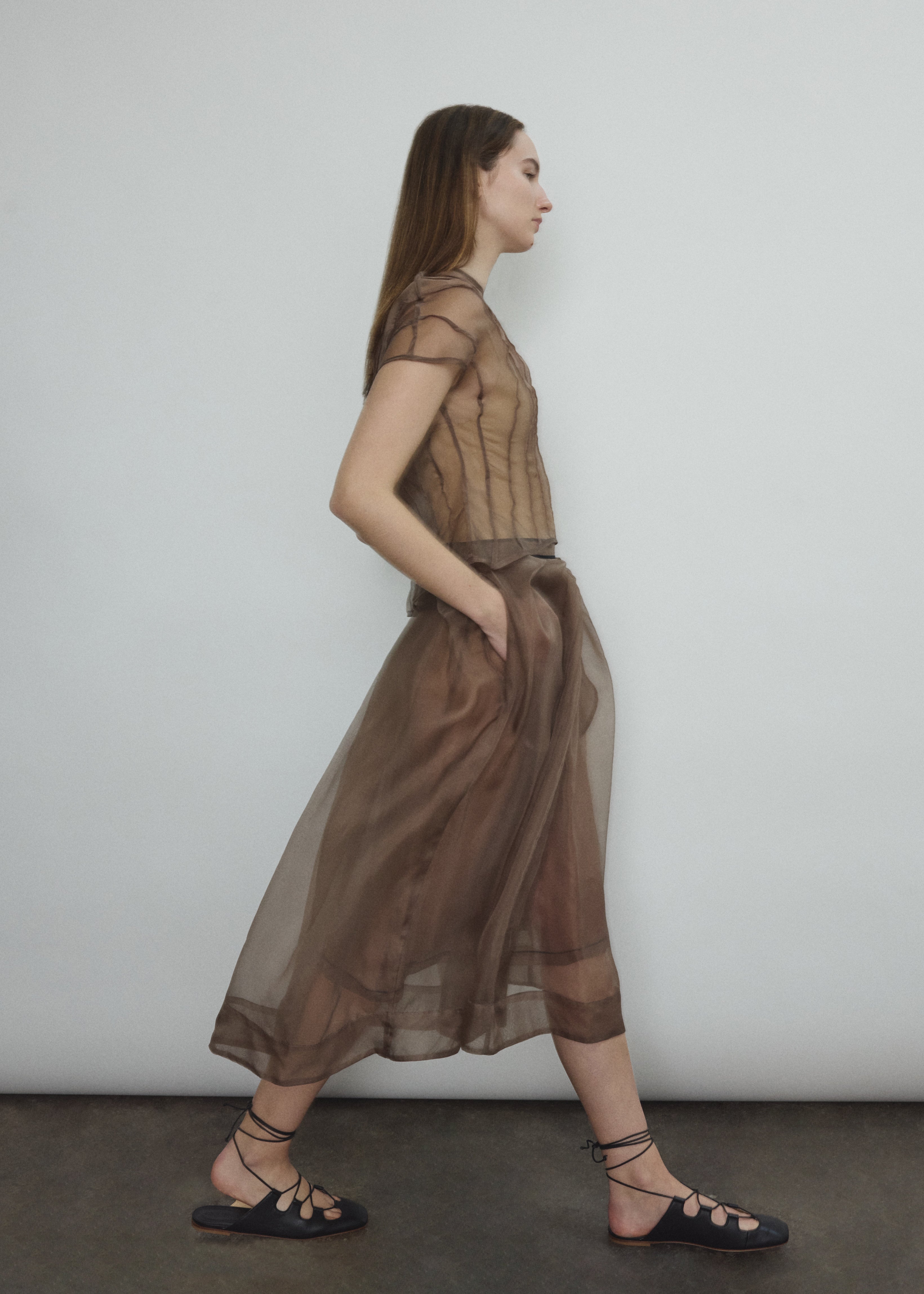Model wearing the Mushroom silk organza Brise Skirt, showcasing its voluminous silhouette, sheer fabric, and elegant midi-length drape.