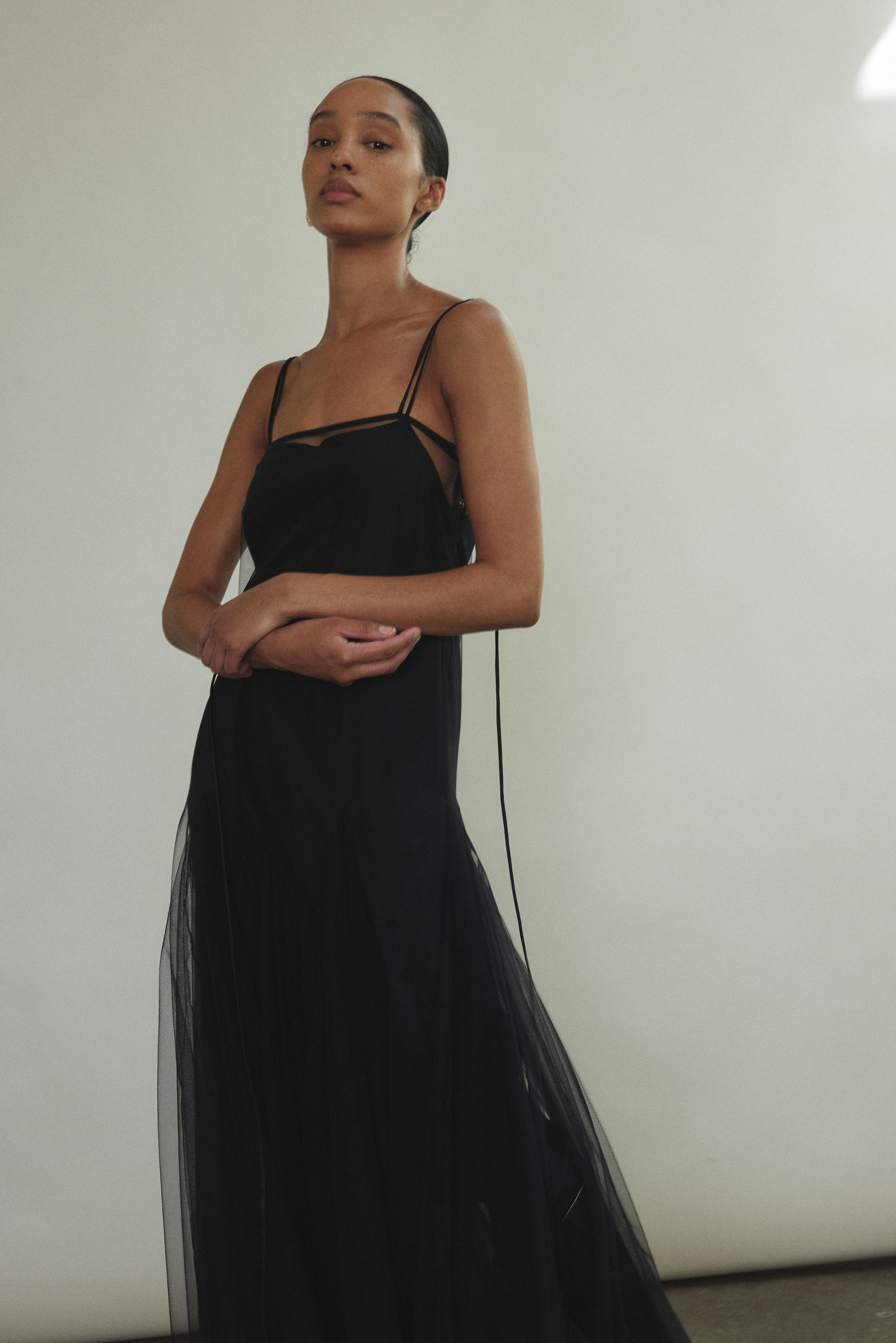 Cropped detail of the black sheer tulle Kamperett Camille Dress bodice with adjustable silk corded straps.