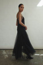Side motion shot of the black sheer tulle Kamperett Camille Dress, showing the godet skirt in movement.