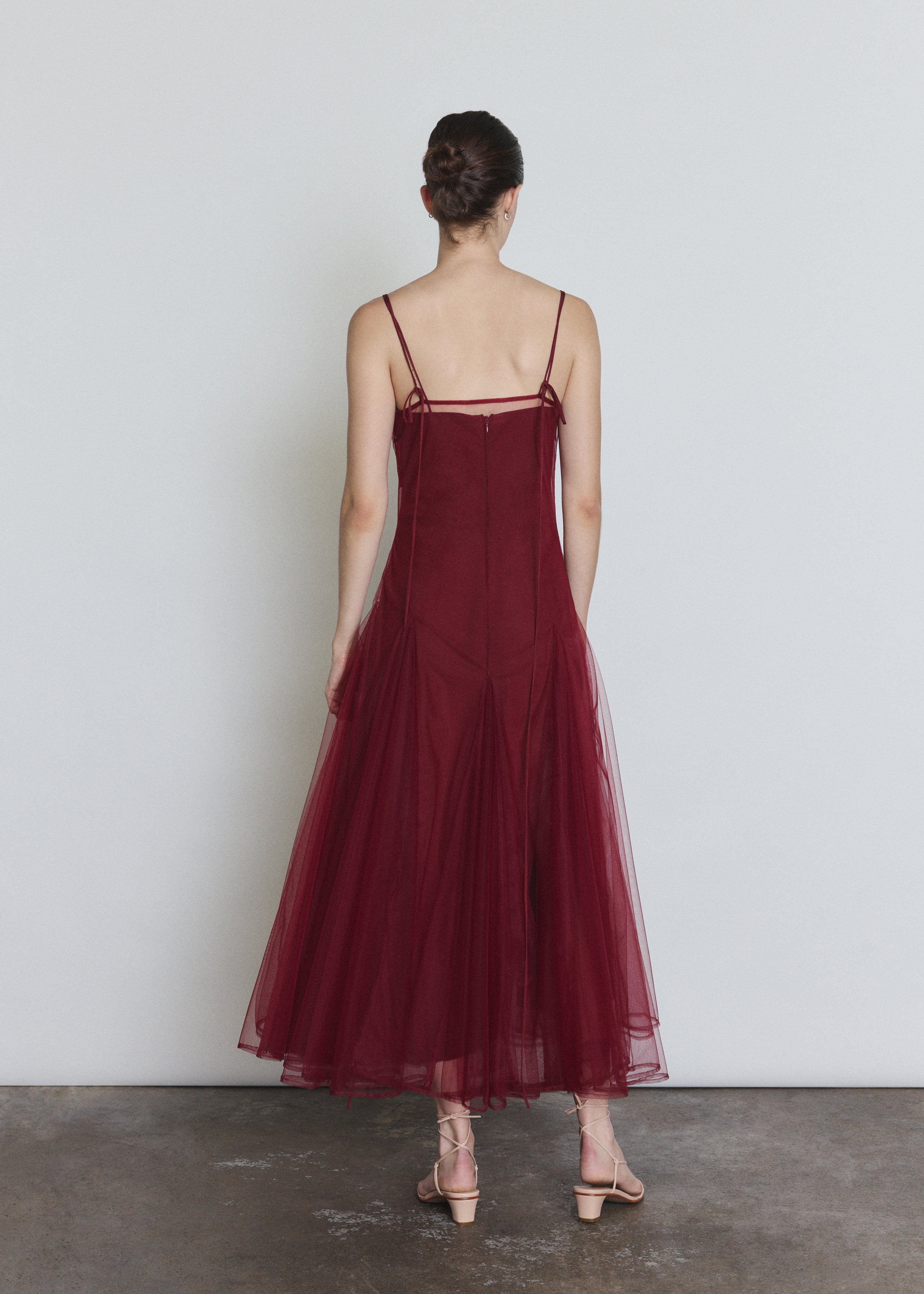Back view of the bordeaux sheer tulle Kamperett Camille Dress showing the straight-cut bodice.