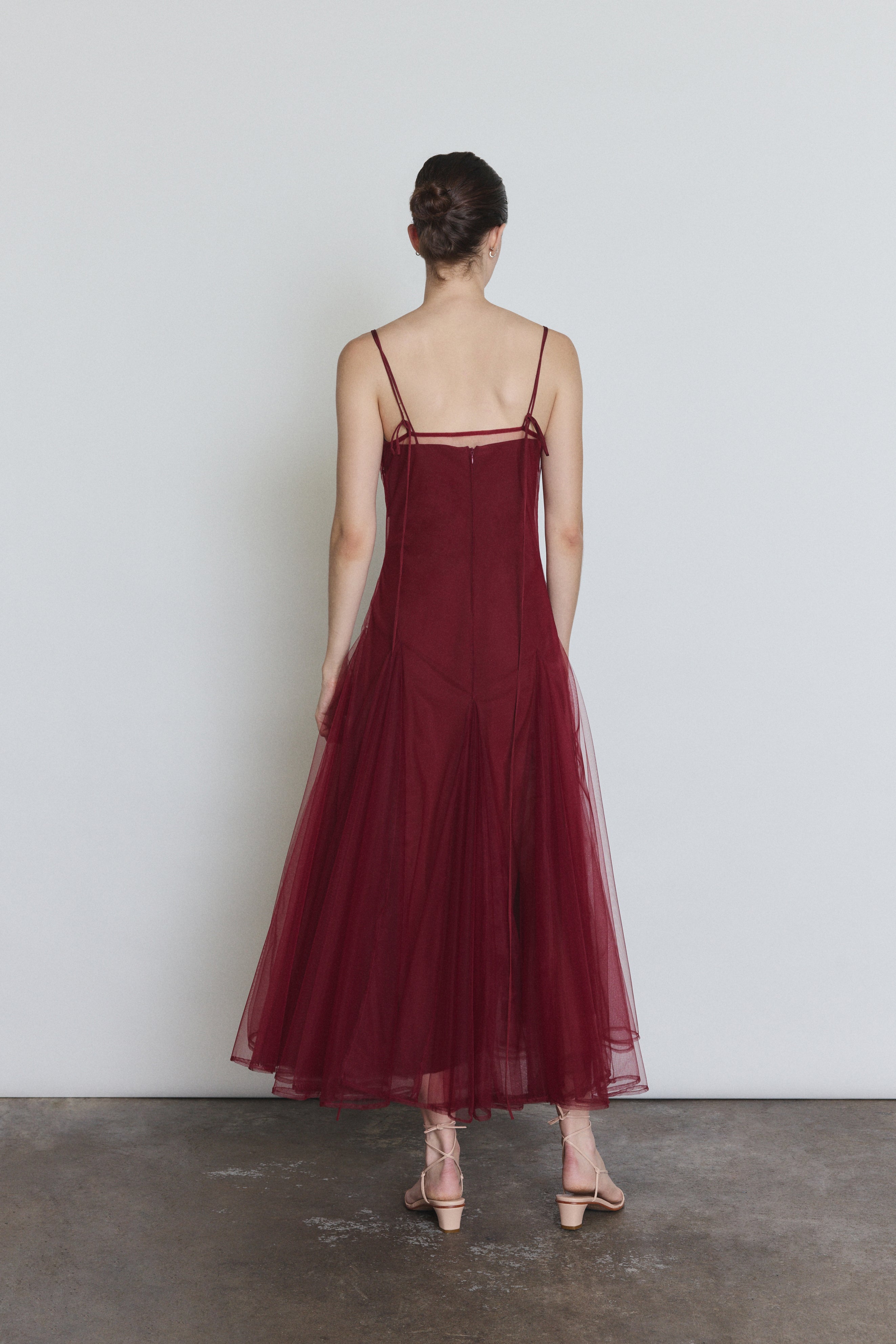 Back view of the bordeaux sheer tulle Kamperett Camille Dress showing the straight-cut bodice.