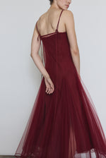 Model wearing the bordeaux Kamperett Camille Dress layered over the Theodora Slip Dress in Bordeaux.
