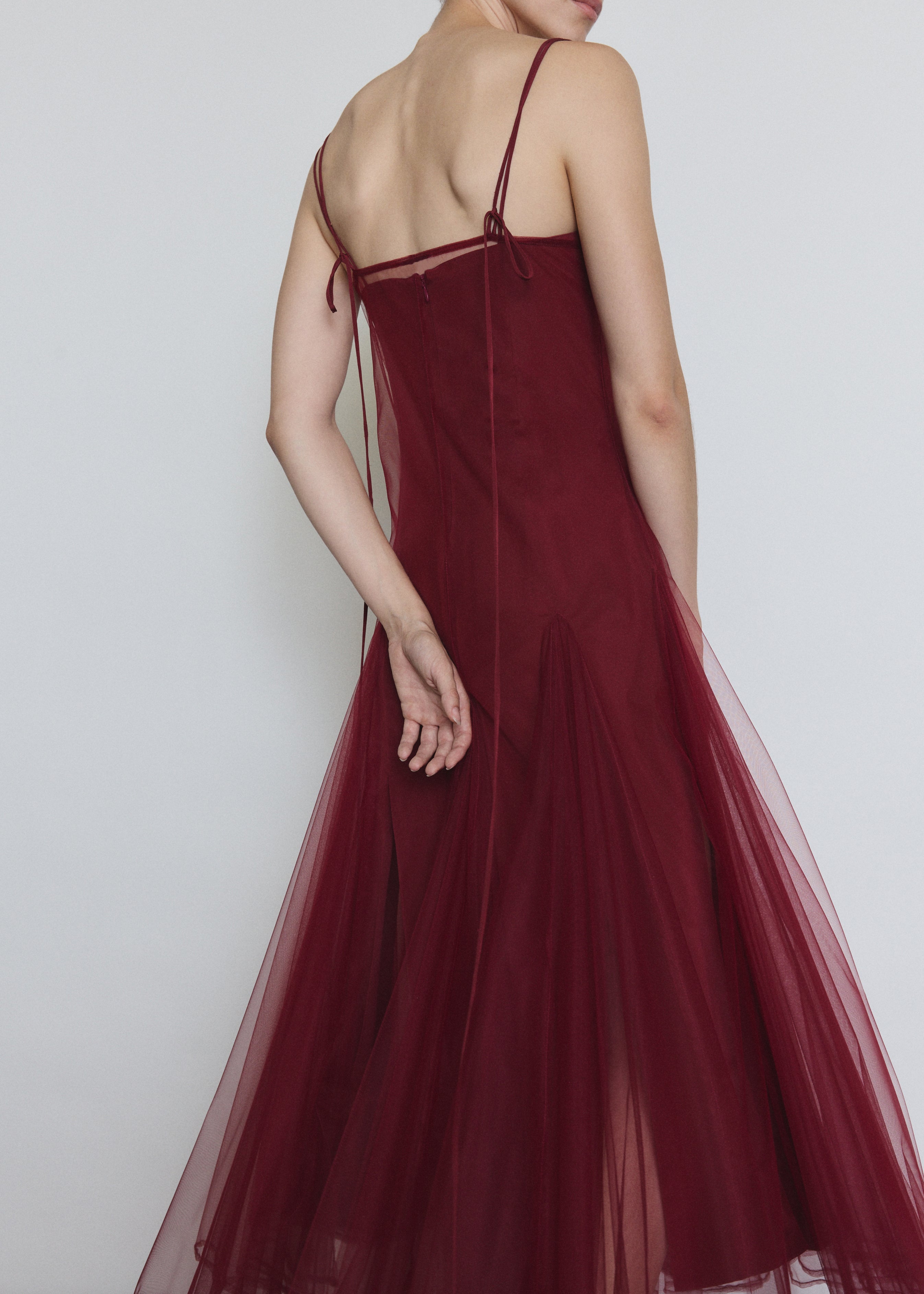Model wearing the bordeaux Kamperett Camille Dress layered over the Theodora Slip Dress in Bordeaux.