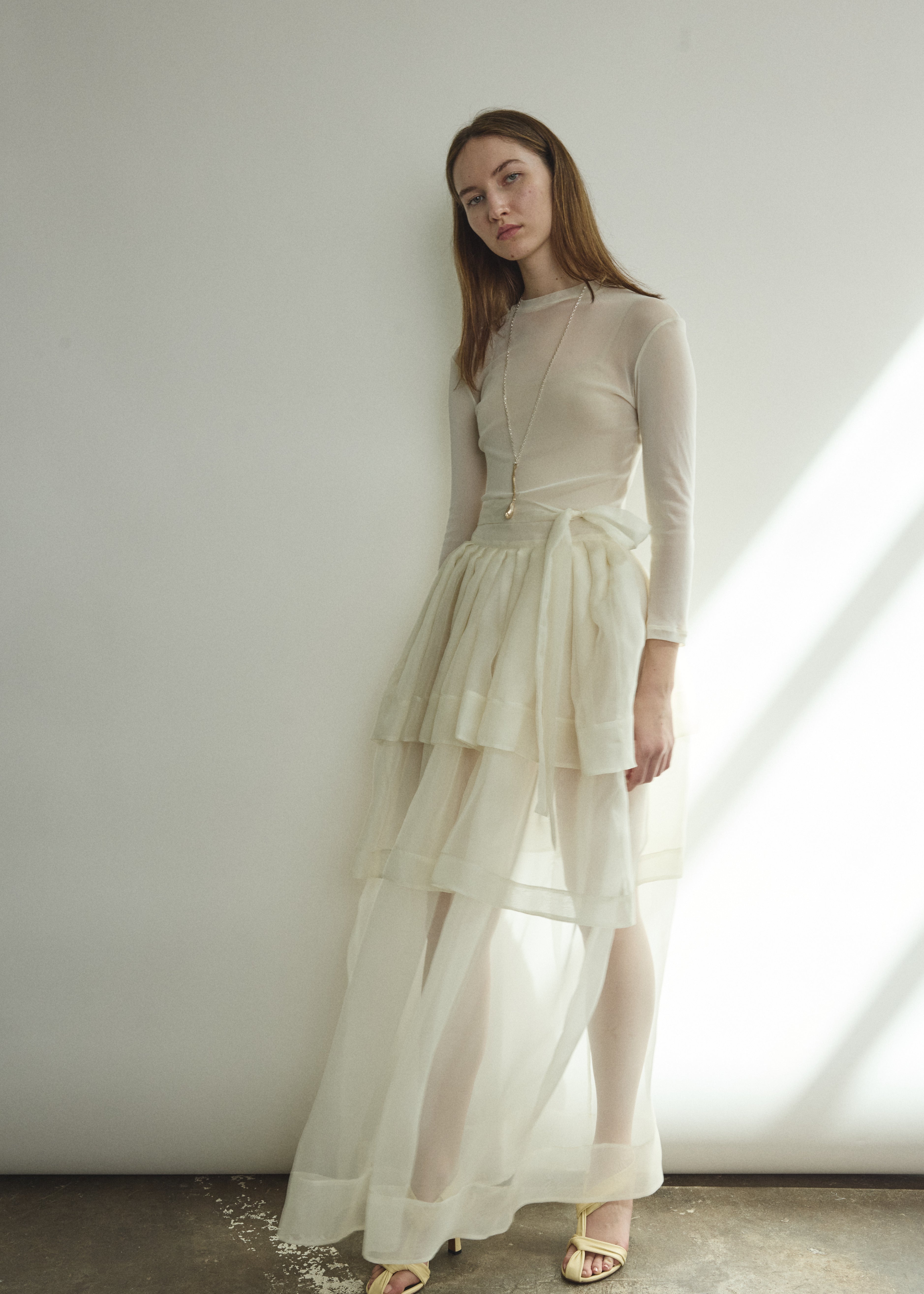 Back view of the alabaster sheer silk organza Kamperett Canna Skirt with self-fabric ties wrapped at the waist.