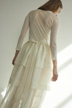 Motion shot of the alabaster Kamperett Canna Skirt layered over the Brise Skirt for a modern bridal look.