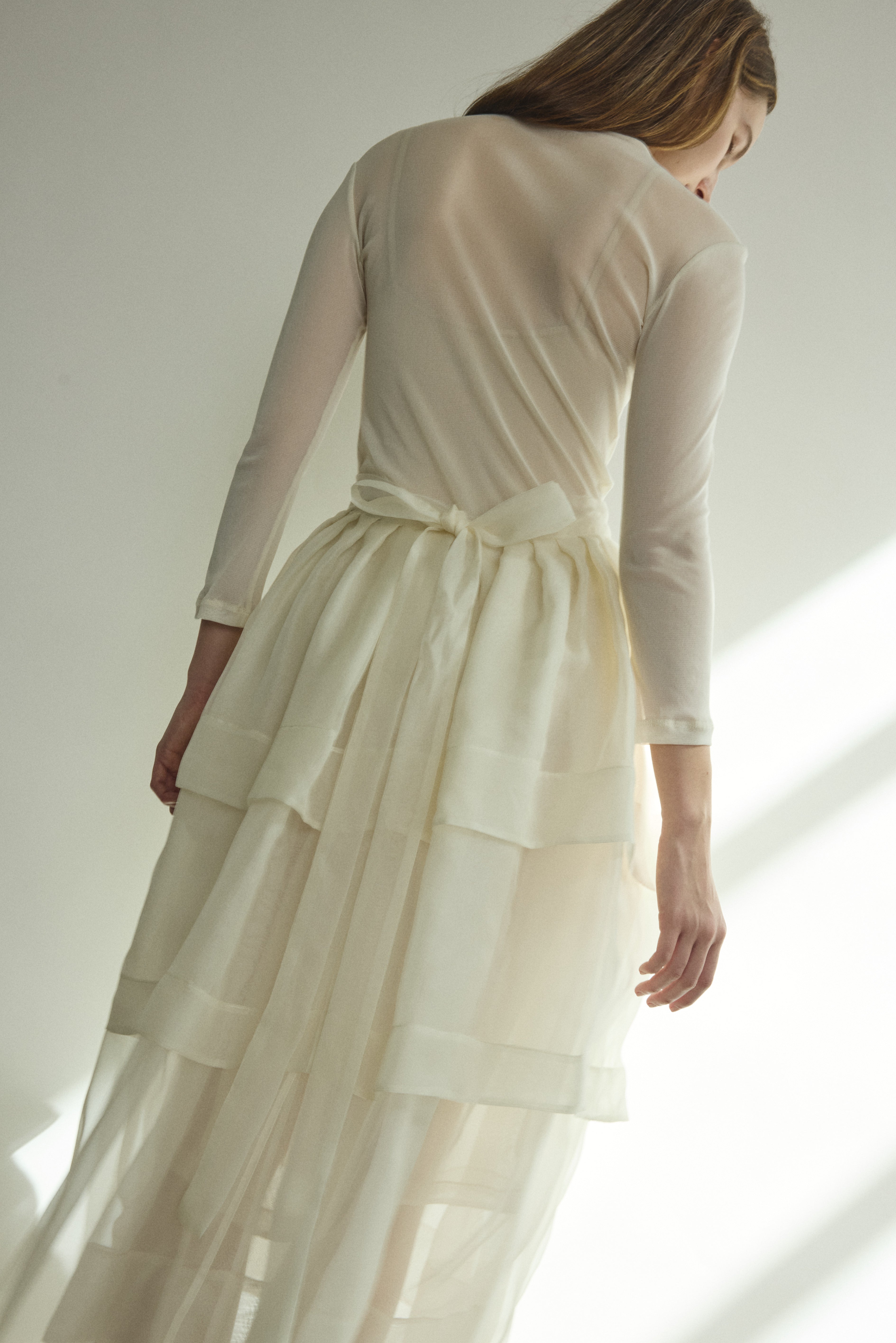 Motion shot of the alabaster Kamperett Canna Skirt layered over the Brise Skirt for a modern bridal look.