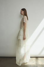 Side view of the alabaster Kamperett Canna Skirt layered over the Brise Skirt in matching alabaster.