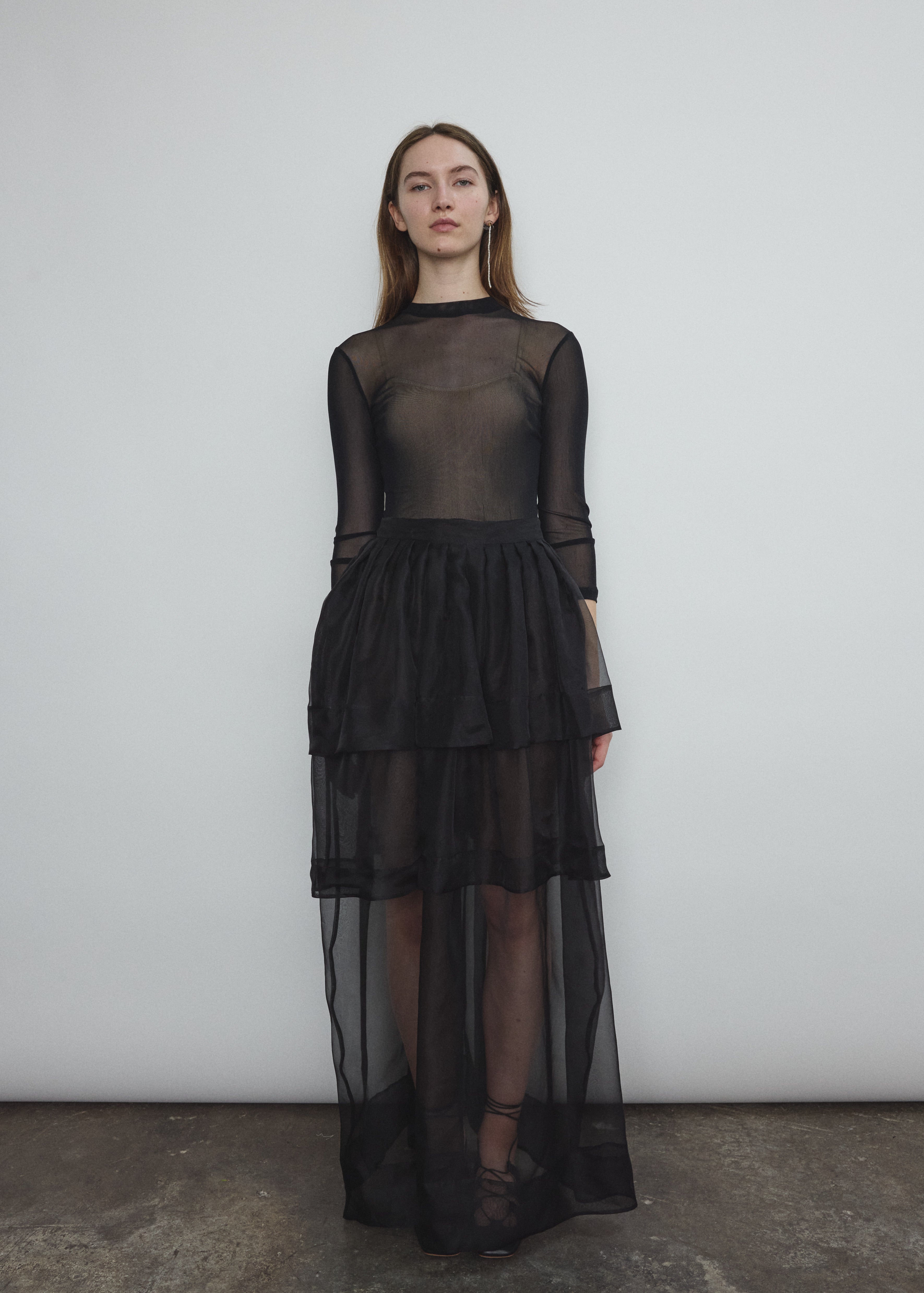 Front view of the black sheer silk organza Kamperett Canna Skirt, a multi-tiered pleated maxi.