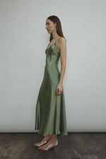 Side view of the jade sueded silk charmeuse Kamperett Caroline Midi Slip Dress, showing the bias-cut drape.