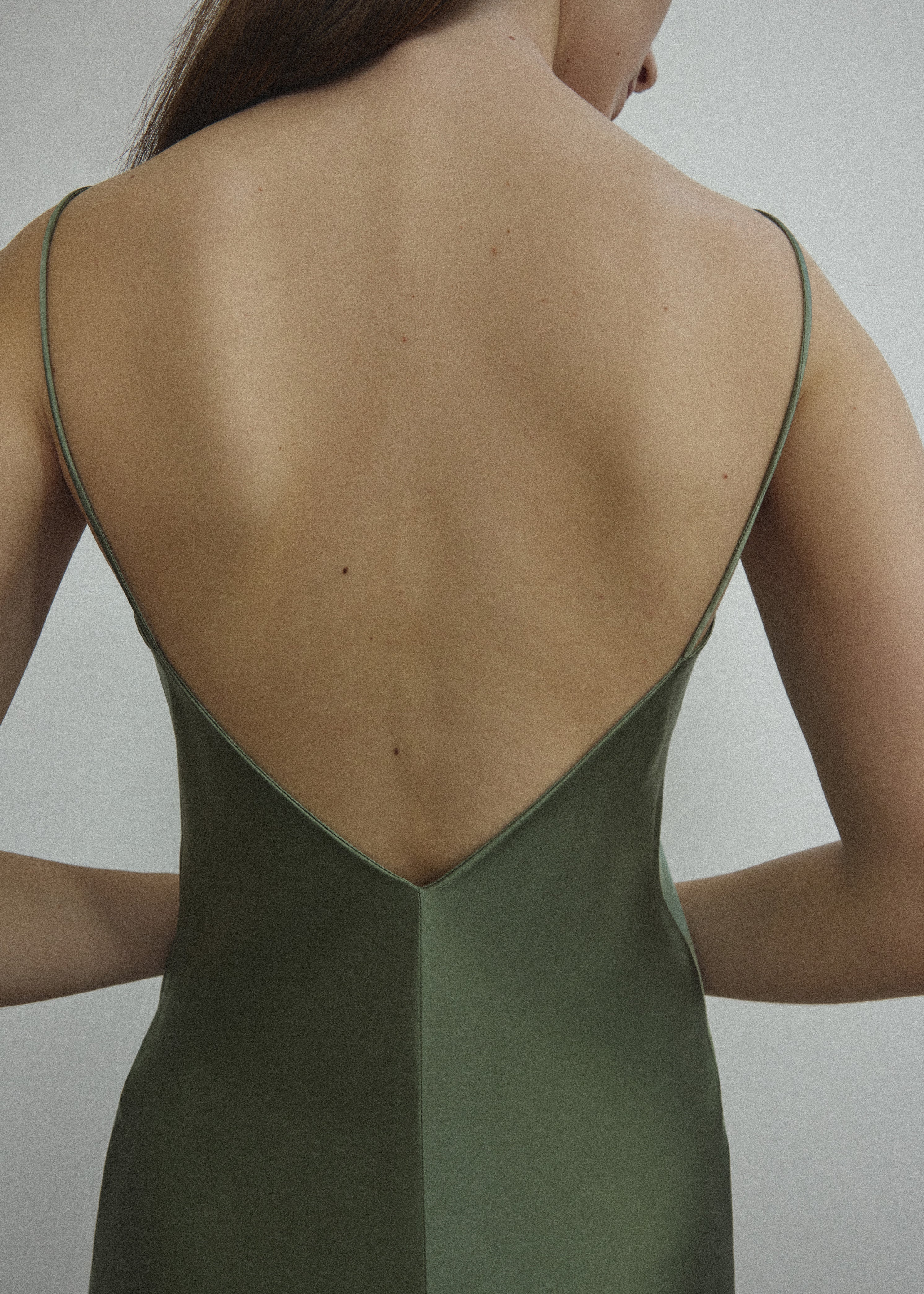 Detail of the corded straps and V-neckline on the jade sueded silk charmeuse Kamperett Caroline Midi Slip Dress.