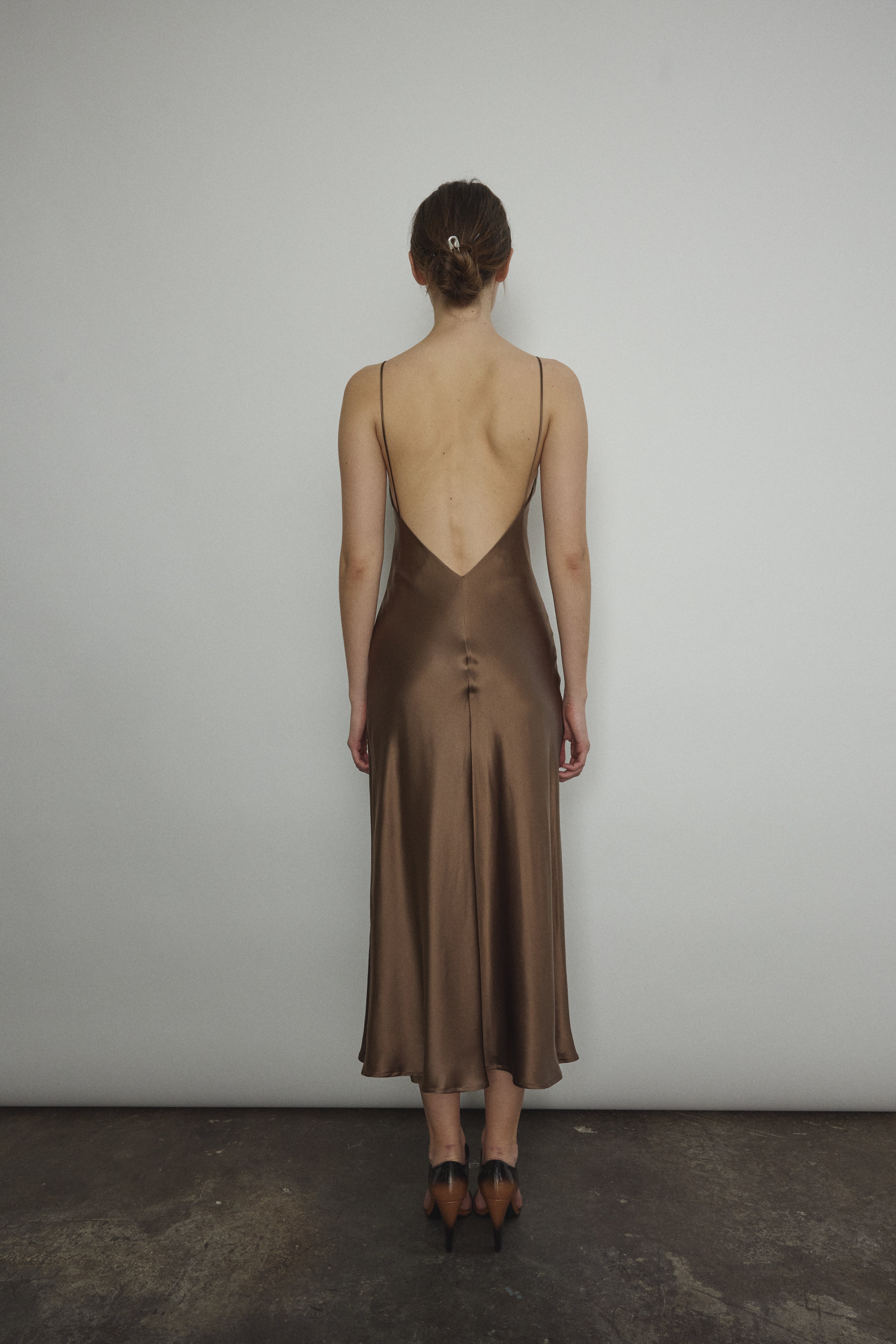 Back view of the mushroom sueded silk charmeuse Kamperett Caroline Midi Slip Dress with V-back neckline.