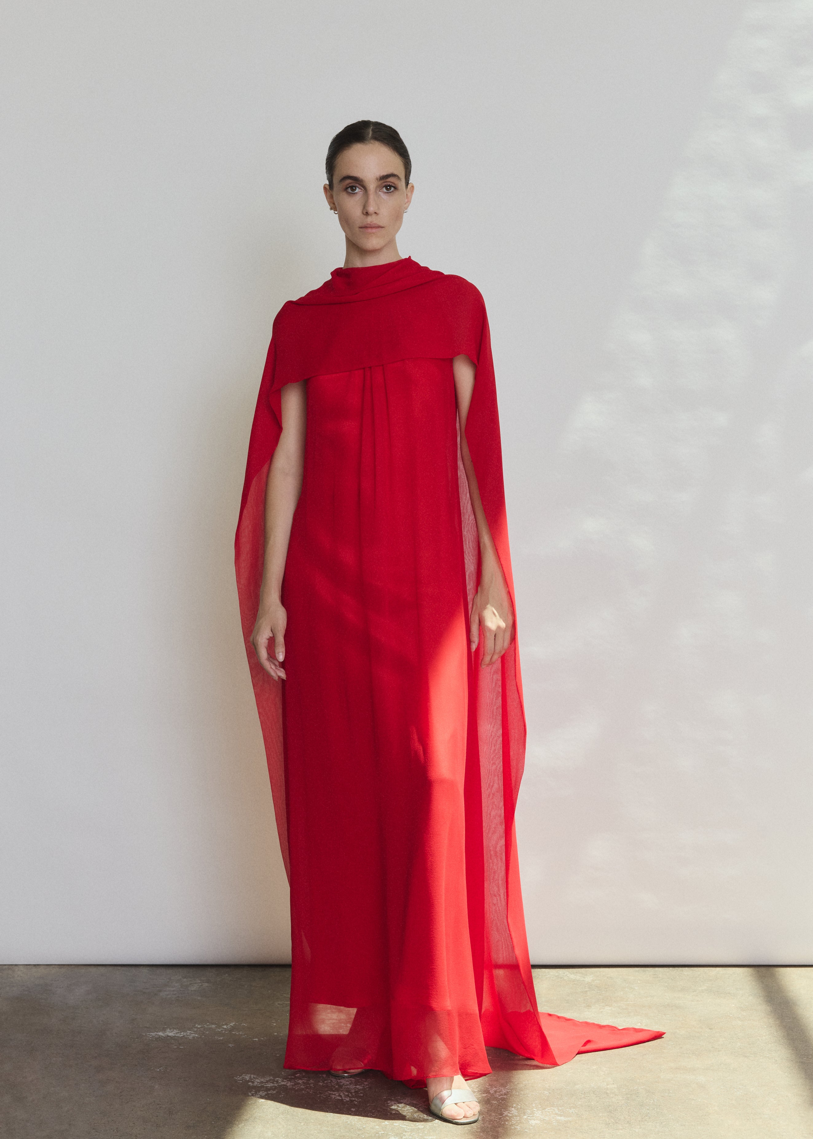 Detail of the crimson silk charmeuse Kamperett Caroline Slip Dress showing the fabric and corded strap construction.