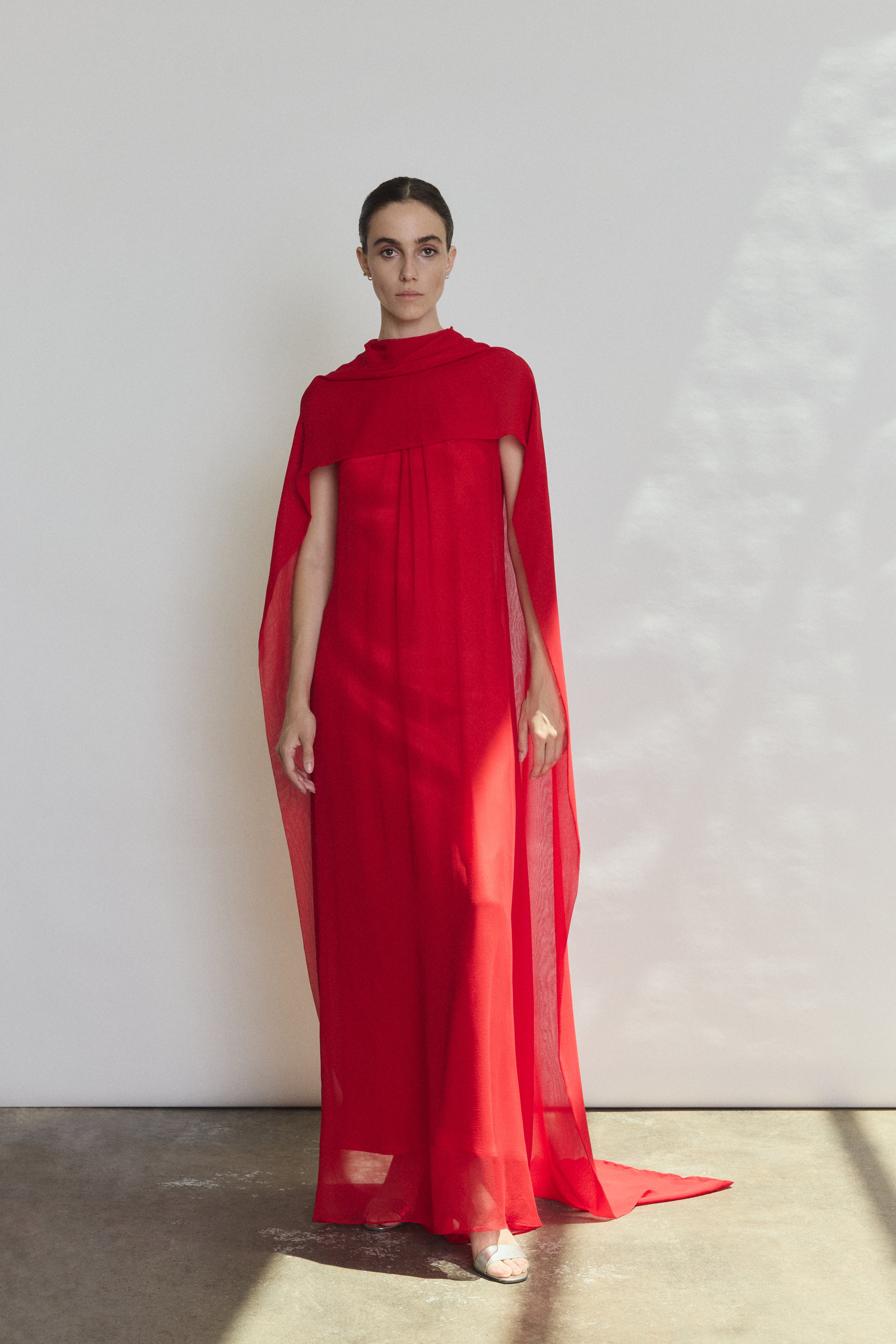 Detail of the crimson silk charmeuse Kamperett Caroline Slip Dress showing the fabric and corded strap construction.