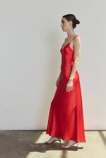 Side view of the crimson silk charmeuse Kamperett Caroline Slip Dress showing the bias-skimming silhouette.