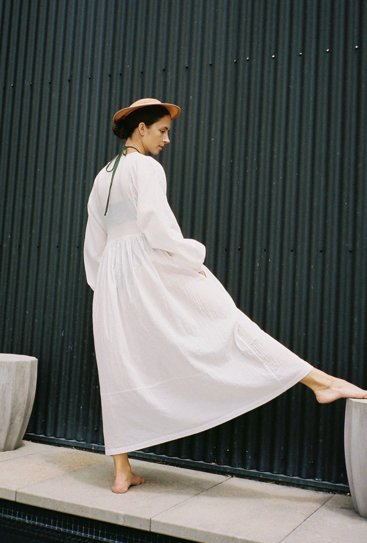 Angled view of the semi-sheer white stripe Japanese cotton voile Kamperett Cassatt Dress.