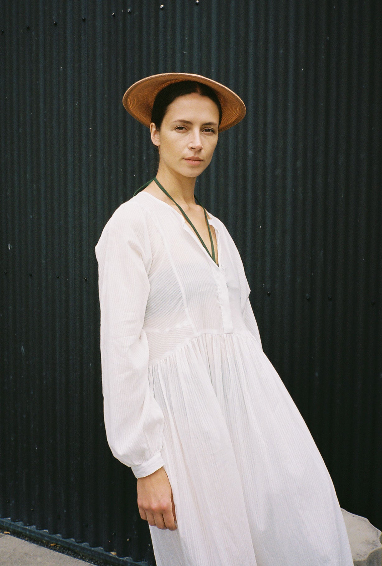 Side view of the semi-sheer white stripe Japanese cotton voile Kamperett Cassatt Dress with self-belt at the waist.