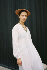 Side view of the semi-sheer white stripe Japanese cotton voile Kamperett Cassatt Dress with self-belt at the waist.