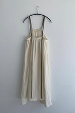 Back view of the ivory Japanese linen Kamperett Cosette Dress showing the adjustable corded back straps.