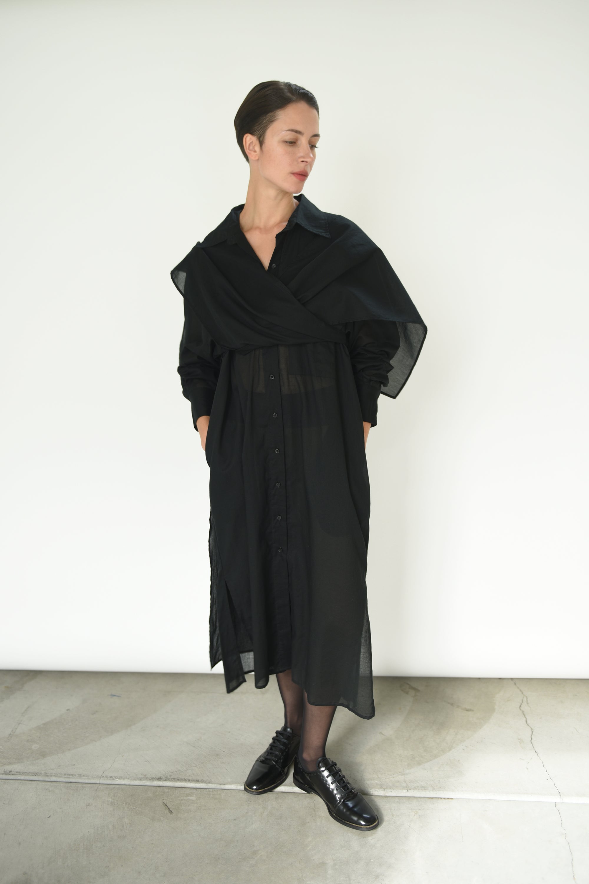 Angled view of the black semi-sheer Japanese cotton voile Kamperett Etude Shirt Dress.