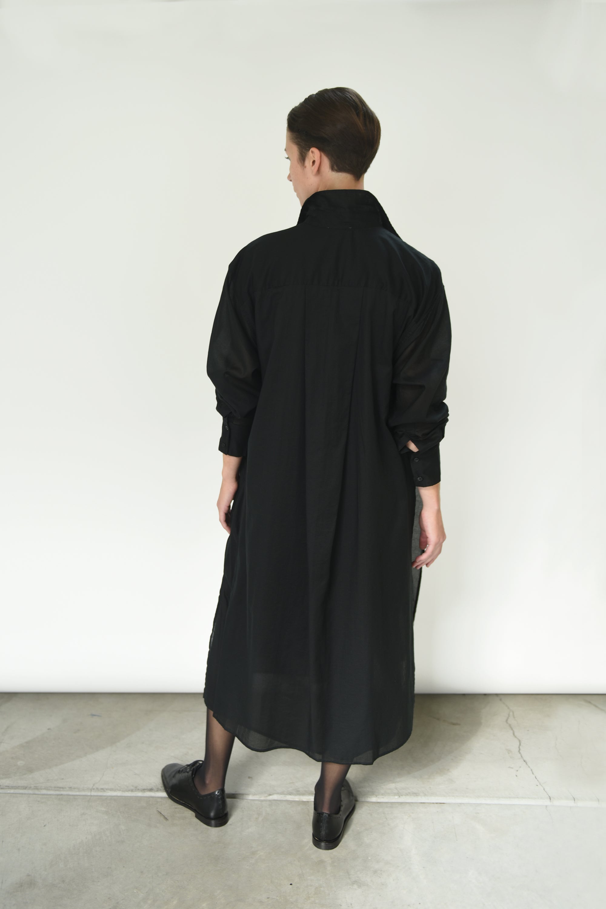Back view of the black Kamperett Etude Shirt Dress showing the large box-pleat at center back.