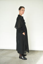 Alternate editorial image of the black Kamperett Etude Shirt Dress.