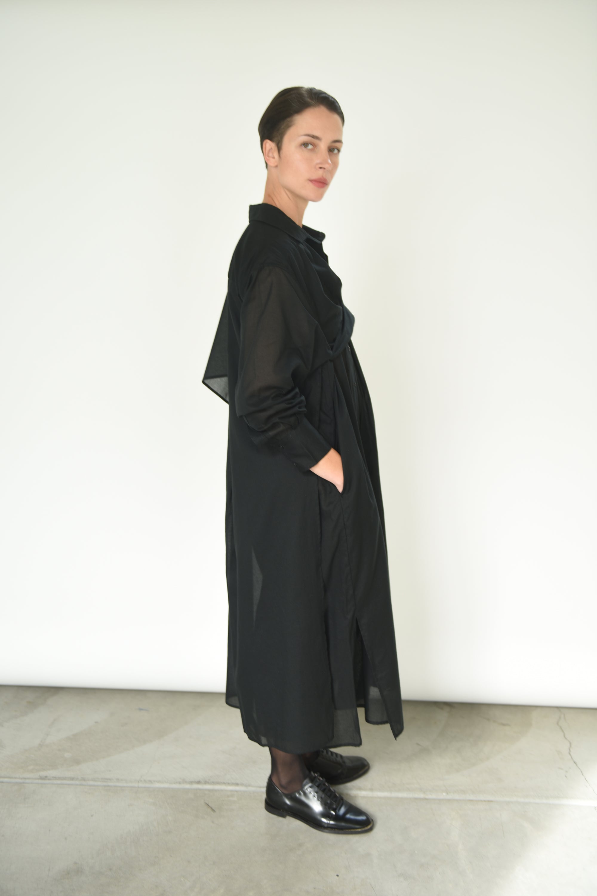 Alternate editorial image of the black Kamperett Etude Shirt Dress.