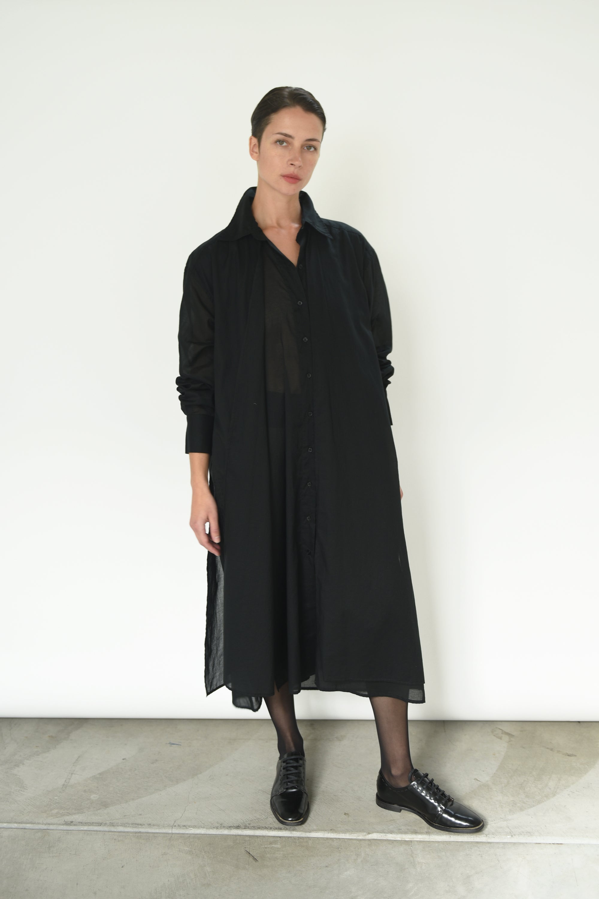 Front view of a model wearing the black semi-sheer Japanese cotton voile Kamperett Etude Shirt Dress.