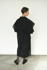 Detail of the fly-away sheer panel on the black Kamperett Etude Shirt Dress.