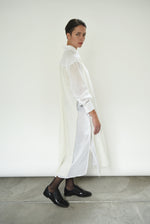 Back view of the white Kamperett Etude Shirt Dress showing the large box-pleat at center back.