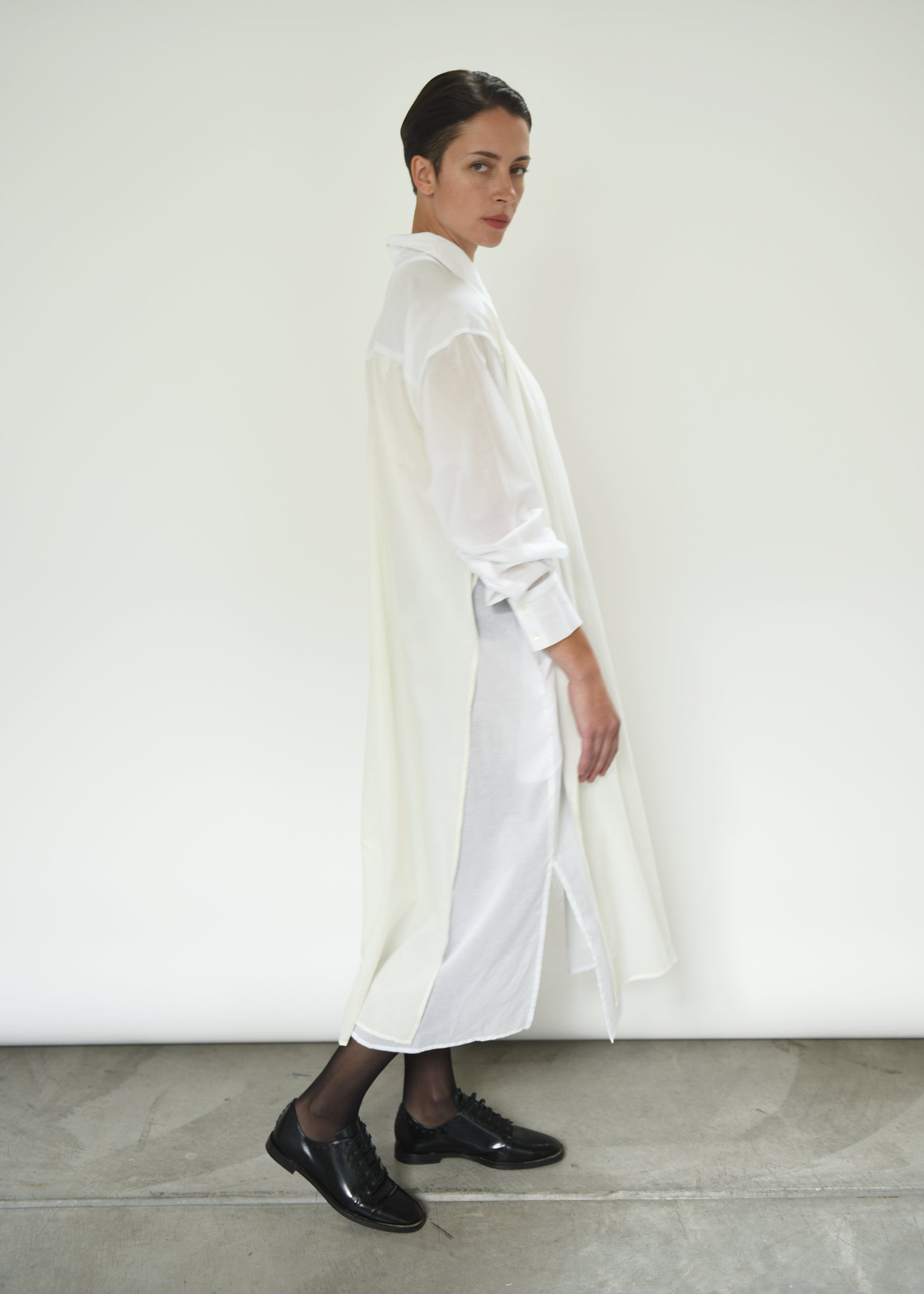 Back view of the white Kamperett Etude Shirt Dress showing the large box-pleat at center back.