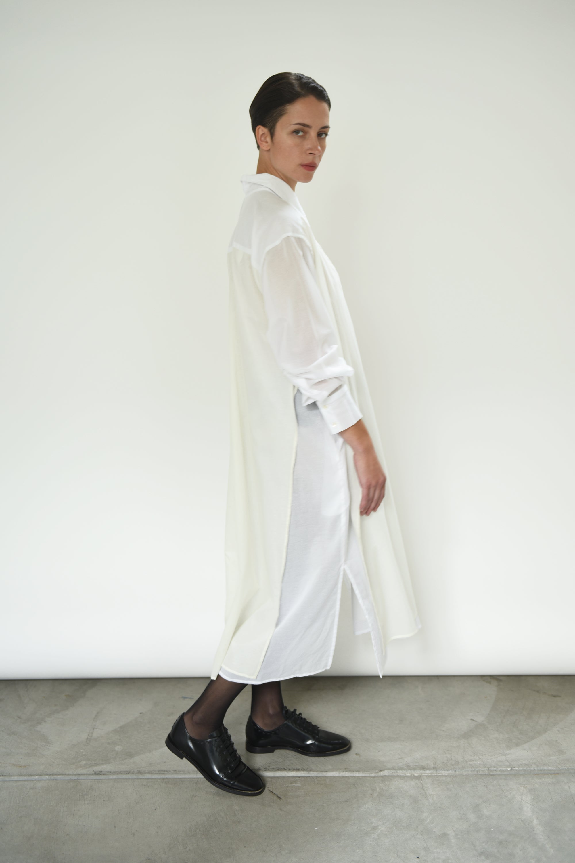 Back view of the white Kamperett Etude Shirt Dress showing the large box-pleat at center back.