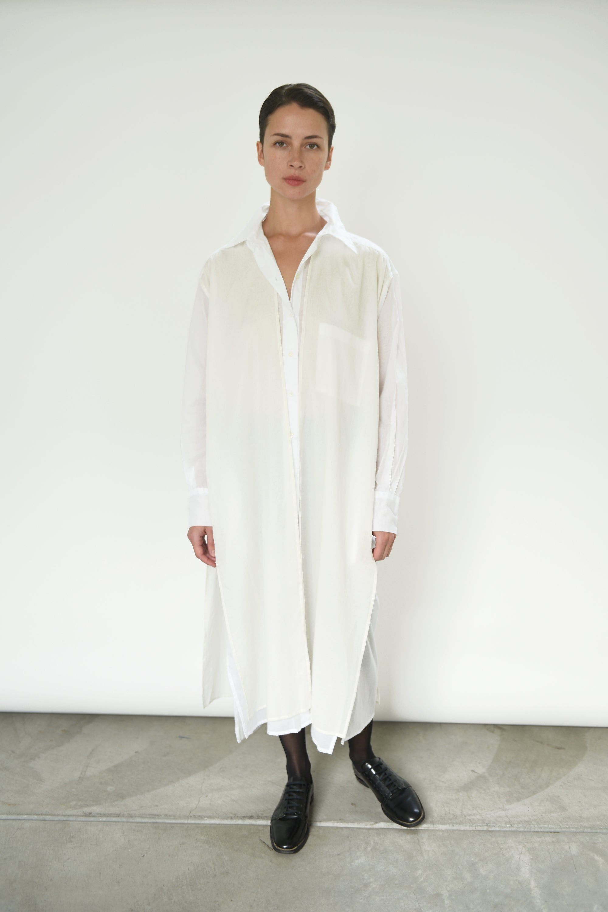 Front view of a model wearing the white semi-sheer Japanese cotton voile Kamperett Etude Shirt Dress.