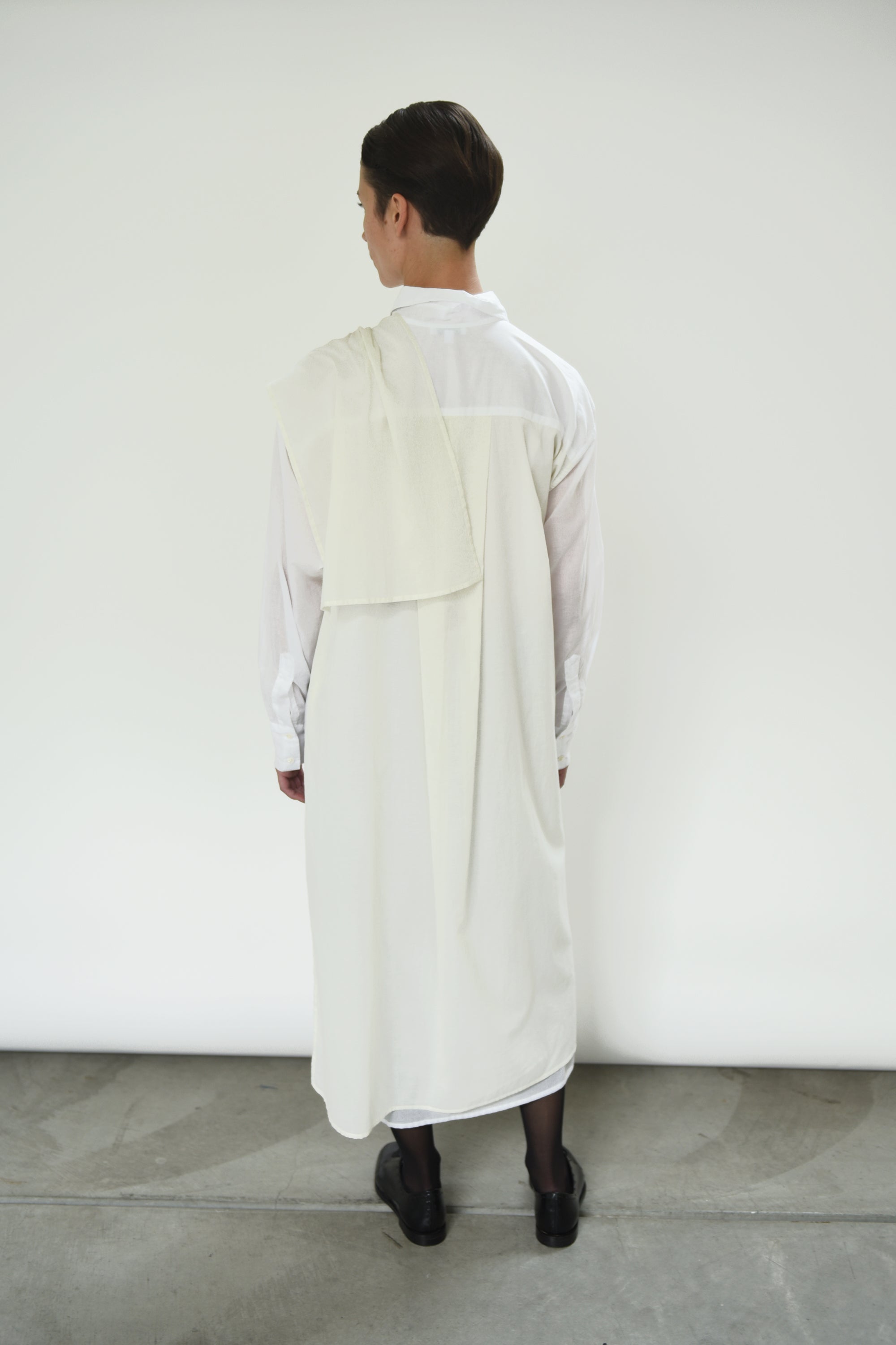 Motion shot of the white Japanese cotton voile Kamperett Etude Shirt Dress, capturing the fluid panel drape.