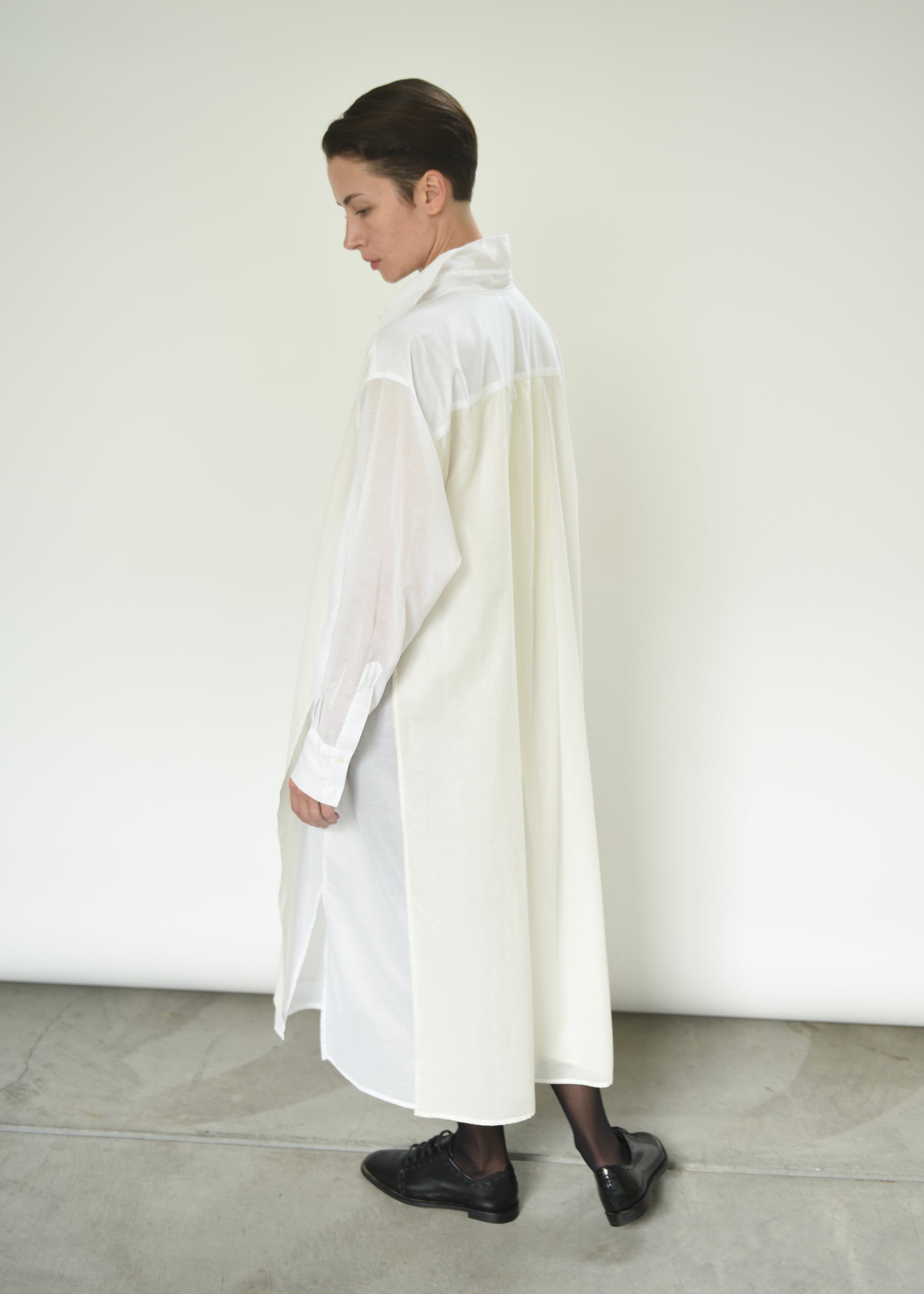 Detail of the fly-away sheer panel on the white Kamperett Etude Shirt Dress.