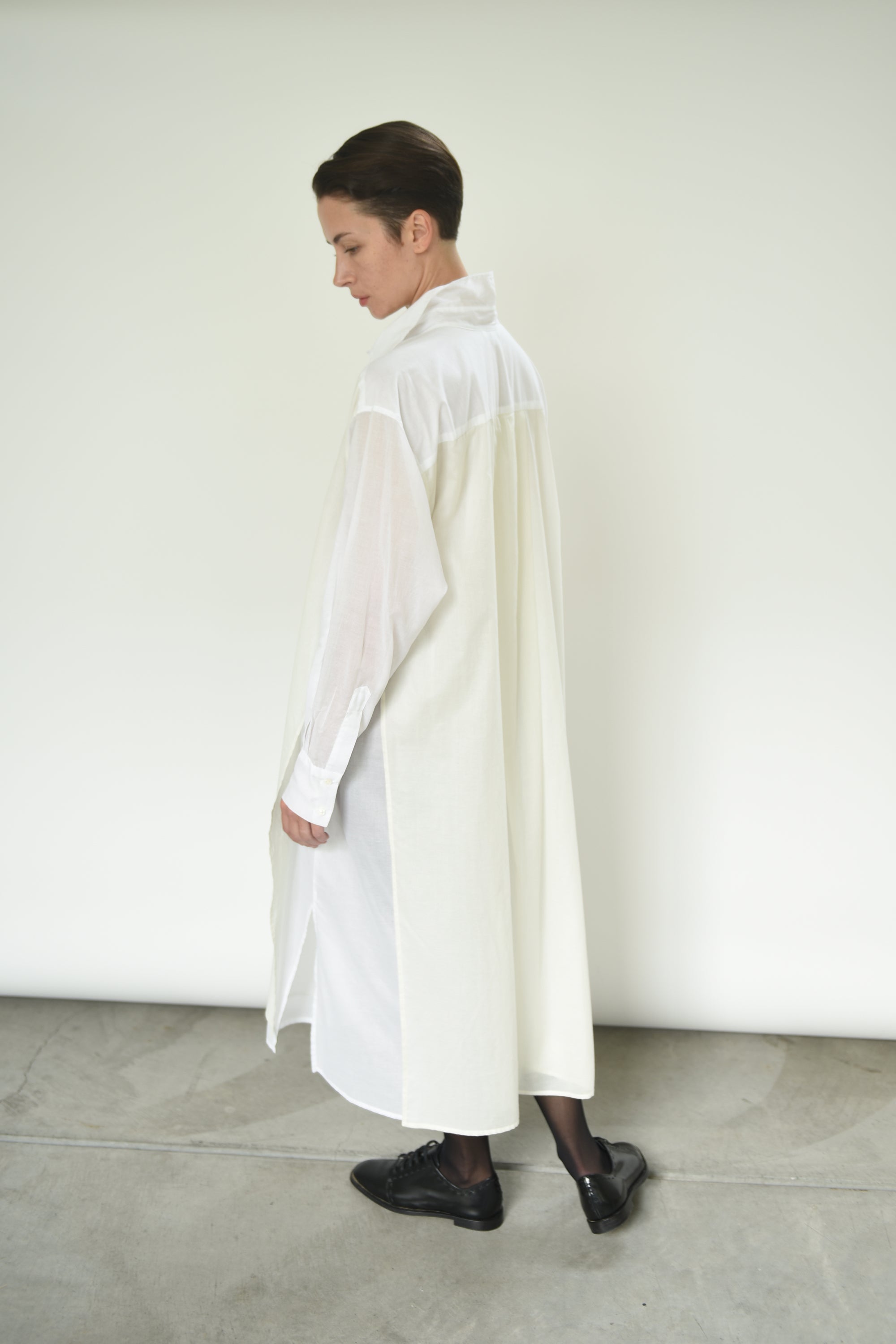 Detail of the fly-away sheer panel on the white Kamperett Etude Shirt Dress.