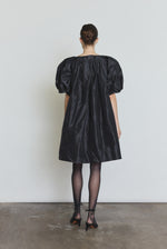 Detail of the black silk taffeta Kamperett Eva Dress showing the asymmetrical pleat construction at the neckline.