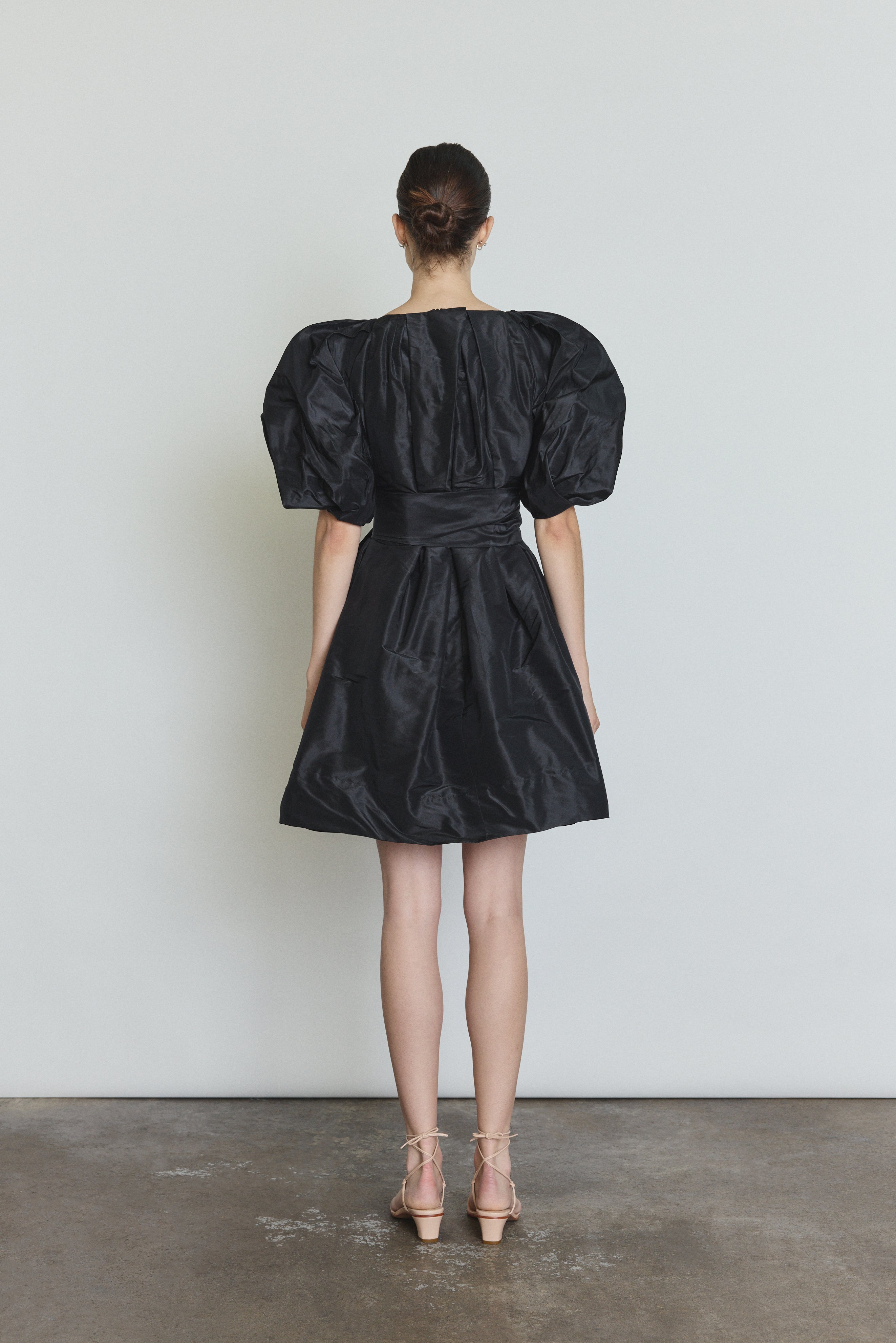 Editorial image of the black Kamperett Eva Dress styled with motion.
