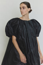 Editorial image of the black Kamperett Eva Dress with the coordinating silk taffeta belt.