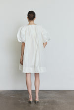 Detail of the white silk taffeta Kamperett Eva Dress showing the asymmetrical pleat construction at the neckline.