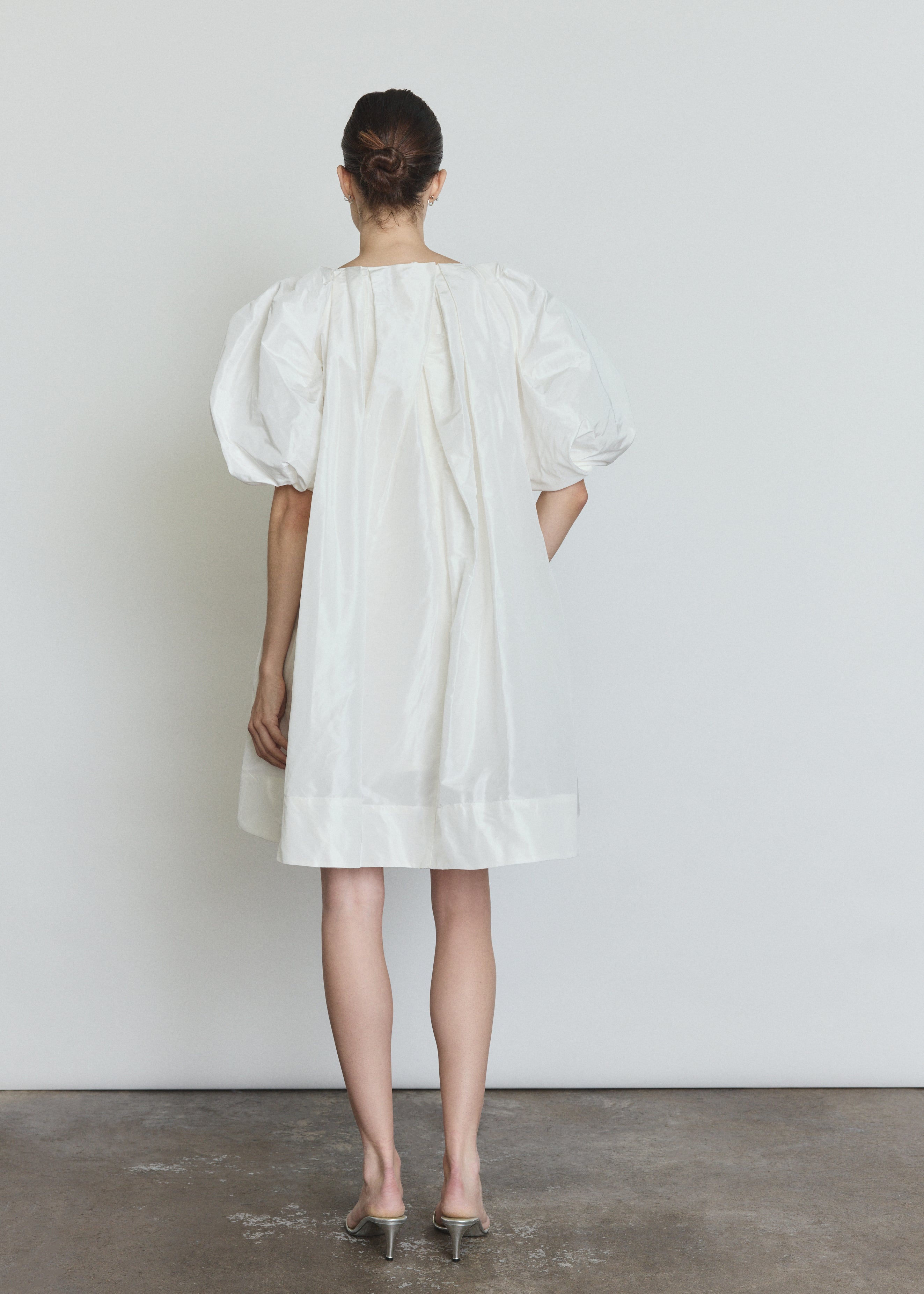 Detail of the white silk taffeta Kamperett Eva Dress showing the asymmetrical pleat construction at the neckline.