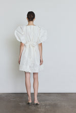 Editorial image of a bride wearing the white Kamperett Eva Dress, a modern sculptural silk taffeta bridal mini.