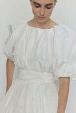 Editorial image of the white Kamperett Eva Dress showing the full bridal A-line silhouette.